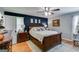 Comfortable main bedroom featuring a ceiling fan and light gray walls with a striking dark accent wall at 75 Barber Rd, Carrollton, GA 30116