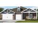 Charming single-story home with brick and siding, featuring a three-car garage and well-manicured lawn at 100 Grande Bishop Dr, Fairburn, GA 30213