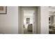 This view down the hallway highlights an open floorplan into a seating area with natural light at 100 Grande Bishop Dr, Fairburn, GA 30213