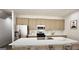 Large kitchen island with seating, stainless appliances, and modern finishes at 100 Grande Bishop Dr, Fairburn, GA 30213