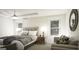This bright bedroom boasts a comfortable bed, nightstands, and a cozy seating area by the windows at 100 Grande Bishop Dr, Fairburn, GA 30213