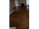 Open living room with hardwood floors and a cozy fireplace at 6420 Pinebark Way, Morrow, GA 30260
