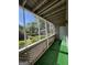 Inviting screened porch features green carpet and lattice design with scenic views at 6420 Pinebark Way, Morrow, GA 30260