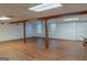 Open basement area featuring wood-look flooring and support beams with natural light at 726 Mcdaniel Mill Sw Rd, Conyers, GA 30094