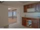 Basement kitchenette with vintage cabinets and views into another large room at 726 Mcdaniel Mill Sw Rd, Conyers, GA 30094