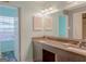 Bright bathroom featuring double sinks, a large mirror, and ample natural light from the window at 726 Mcdaniel Mill Sw Rd, Conyers, GA 30094