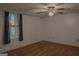 Bedroom with hardwood flooring, a ceiling fan and a window with vertical blinds at 726 Mcdaniel Mill Sw Rd, Conyers, GA 30094