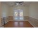 Cozy dining room with wainscoting and glass French doors at 726 Mcdaniel Mill Sw Rd, Conyers, GA 30094