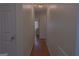 Hallway with wood floors and neutral wall color at 726 Mcdaniel Mill Sw Rd, Conyers, GA 30094