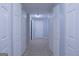 Bright hallway with neutral paint, flooring, and multiple closet doors at 726 Mcdaniel Mill Sw Rd, Conyers, GA 30094