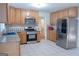 Spacious kitchen with stainless steel appliances and ample cabinet space at 726 Mcdaniel Mill Sw Rd, Conyers, GA 30094