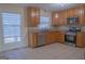Well-lit kitchen featuring stainless steel appliances, tile backsplash, and window at 726 Mcdaniel Mill Sw Rd, Conyers, GA 30094