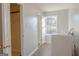 Functional laundry room with modern machines, a bright window and a storage area at 726 Mcdaniel Mill Sw Rd, Conyers, GA 30094