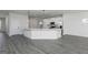Open kitchen with a white island, pendant lighting, and stainless steel appliances at 677 Cantrell Drive, Dallas, GA 30157