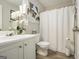 Bathroom featuring a toilet, a shower with a white curtain, and a vanity with white cabinets at 1444 Gates Se Cir, Atlanta, GA 30316