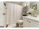 Bathroom featuring a toilet, a shower with a white curtain, and a vanity with white cabinets at 1444 Gates Se Cir, Atlanta, GA 30316