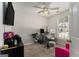 Bedroom with a ceiling fan and a desk area with a gray upholstered stool at 1444 Gates Se Cir, Atlanta, GA 30316
