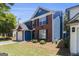Two story brick and blue home with a front yard and an attached garage at 1444 Gates Se Cir, Atlanta, GA 30316