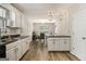 Well-maintained kitchen featuring white cabinetry, granite countertops, breakfast bar and wood flooring at 1444 Gates Se Cir, Atlanta, GA 30316