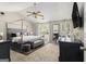 Spacious main bedroom with a four-poster bed, neutral colors, a ceiling fan and carpeted floors at 1444 Gates Se Cir, Atlanta, GA 30316