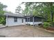 Home exterior features a screened-in porch with a concrete patio, offering a backyard entertaining space at 1590 Colonial South Sw Dr, Conyers, GA 30094