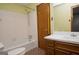 Bathroom features a classic tub and shower combination with a vanity, mirror and tile flooring at 1590 Colonial South Sw Dr, Conyers, GA 30094