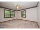 Bright bedroom with carpet, two windows with natural light and ceiling fan in a cozy space at 1590 Colonial South Sw Dr, Conyers, GA 30094