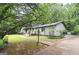 Single-story home featuring a long walkway and a well-maintained lawn at 1590 Colonial South Sw Dr, Conyers, GA 30094