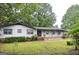 Attractive single-story home featuring a covered front porch and brick accents at 1590 Colonial South Sw Dr, Conyers, GA 30094