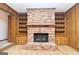 Brick fireplace with built-in shelving and cabinets on each side at 1590 Colonial South Sw Dr, Conyers, GA 30094