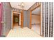 Inviting foyer with decorative wallpaper and openings to other rooms at 1590 Colonial South Sw Dr, Conyers, GA 30094