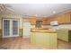 Open kitchen with center island, wood cabinets, and updated appliances at 1590 Colonial South Sw Dr, Conyers, GA 30094