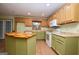 Bright kitchen with two-tone cabinetry, white appliances, and center island at 1590 Colonial South Sw Dr, Conyers, GA 30094