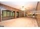 Open-concept living room with wood paneling and view of kitchen and sunroom at 1590 Colonial South Sw Dr, Conyers, GA 30094