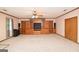 Spacious living room featuring built-in wooden entertainment center and shelving at 1590 Colonial South Sw Dr, Conyers, GA 30094