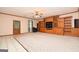 Living room boasting built-in entertainment center and tile-to-carpet flooring transition at 1590 Colonial South Sw Dr, Conyers, GA 30094