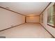 Spacious living room with neutral carpet and trim at 1590 Colonial South Sw Dr, Conyers, GA 30094