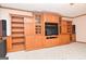Living room featuring a large built-in entertainment center with shelving at 1590 Colonial South Sw Dr, Conyers, GA 30094