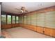 Cozy sunroom with wood paneling and windows, offering a tranquil space to enjoy natural light and views at 1590 Colonial South Sw Dr, Conyers, GA 30094