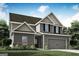 Two-story home featuring gray siding, brick accents, complemented by landscaped yard and a two-car garage at 412 Cantrell Drive, Dallas, GA 30157