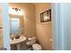 Cozy powder room featuring pedestal sink, toilet and decorative mirror at 6089 Indian Wood Cir, Mableton, GA 30126