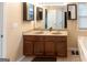 Bathroom featuring double sink vanity, large mirror, and ample counter space at 6089 Indian Wood Cir, Mableton, GA 30126