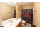 Bright bathroom featuring a single sink vanity and a vibrant, fun-themed shower curtain at 6089 Indian Wood Cir, Mableton, GA 30126