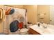 Bathroom with a shower featuring a stylish curtain and a vanity with essential amenities at 6089 Indian Wood Cir, Mableton, GA 30126