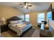 Bedroom featuring a ceiling fan, tv, and windows allowing natural light at 6089 Indian Wood Cir, Mableton, GA 30126