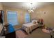 Cozy bedroom with a unique chandelier and charming, personalized wall décor above the bed at 6089 Indian Wood Cir, Mableton, GA 30126
