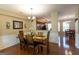 Dining area showcasing hardwood floors, stylish lighting, and seamless connection to the kitchen at 6089 Indian Wood Cir, Mableton, GA 30126