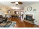 Inviting living room with a fireplace, hardwood floors, and an open layout to the dining area at 6089 Indian Wood Cir, Mableton, GA 30126