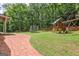 Expansive backyard features a trampoline and wooden playset, perfect for Gathering fun at 305 Postwood Dr, Fayetteville, GA 30215