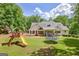 Large backyard with playground and trampoline at 305 Postwood Dr, Fayetteville, GA 30215
